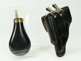 a small black object in a glass container next to a small black object