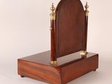 an image of a wooden clock with a mirror on top of it