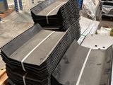 several pieces of metal are stacked on top of each other in a warehouse
