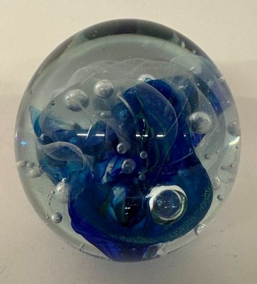 a glass ball with a blue and white design on it