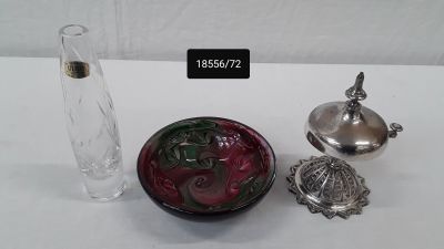 a small glass vase and a small glass container on a table
