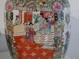 a large vase with a painting on it on display