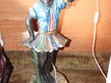 a statue of a woman holding a basket of fruit