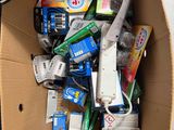 a cardboard box filled with assorted items on the floor