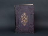 an old purple book with a gold design on it on a black background