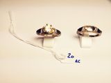 pair of gold tone rings with black and white stones on them
