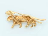 an image of a gold dog broochle on a white background