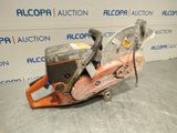 a chainsaw sitting on top of a table in front of a wall