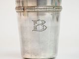 an old silver cup with a monogram on the side of it