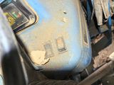 a close up of a blue motorcycle with a number plate on it