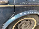 a close up of a tire on a blue car