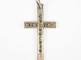 a close up of a silver cross on a white background
