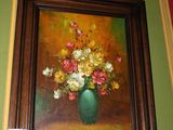a painting of flowers in a vase on the wall