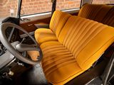 a yellow seat in a car with a steering wheel