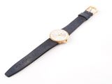a close up of a watch on a white surface with a white background