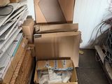 a pile of cardboard boxes and other items in a room