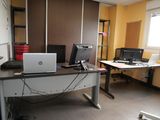 a desk with two computers and a laptop on it