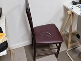 a desk with a chair and a laptop on it