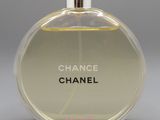 a close up of a bottle of perfume on a gray surface
