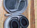 a pair of headphones in a case on a wooden floor