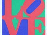 a red, green and blue love sign with the word love on it