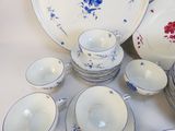 a lot of plates and cups on the table