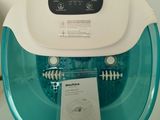 a blue and white foot spa machine on a glass table