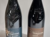 two bottles of wine sitting next to each other on a table