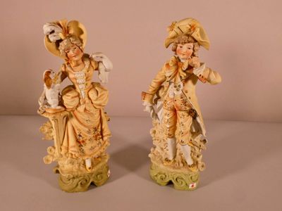 pair of antique figurines of a woman and a child