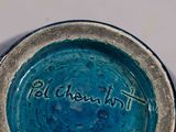 a close up of a blue bowl with writing on it