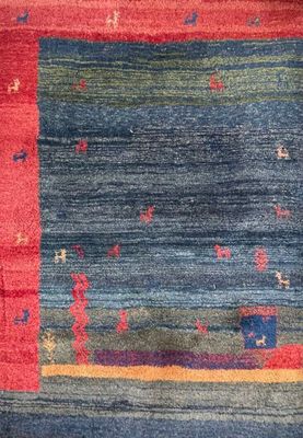 a close up of a colorful rug on a wooden floor