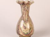 a glass vase with a multicolored design on it