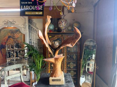 a statue of a deer in a vase on a table