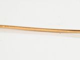 pearl and gold hair pin on white surface with reflection