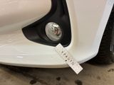 a close up of a white car with a sticker on it