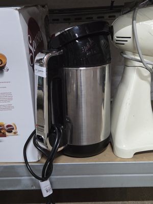 a picture of a coffee maker on a shelf in a store