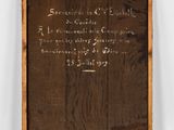 an old wooden plaque with writing on it on a white wall