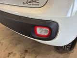 a close up of a white car with a sticker on it