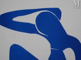 a picture of a woman in a blue dress on a white wall