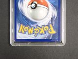 a pokemon card in a plastic case on a table