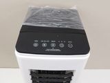 a white and black air conditioner sitting on a table