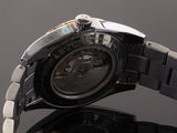 an image of a close up of a watch on a black surface
