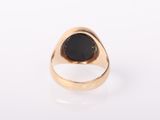 a gold ring with a black stone in the center