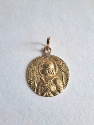 a close up of a gold medal on a white surface