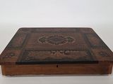 an old wooden box with a decorative design on it