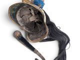 an old helmet and a pair of scissors on a white surface