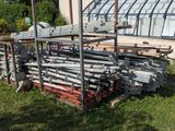 a pile of pipes sitting in front of a building