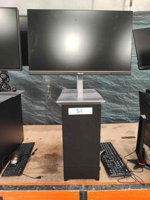 three computer monitors and a keyboard on a table