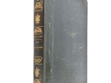 an old book sitting on top of a table next to a white background