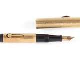 an image of a gold pen and a black pen sitting next to each other